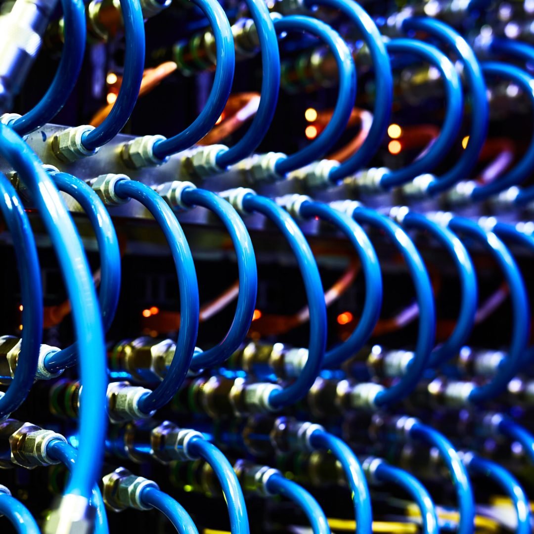 Network hub and server rack with connection cables toned in blue color